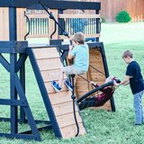 Lifestyle image of a child climbing the wall, and two children using the web swing Lifestyle image of a child climbing the wall, and two children using the web swing