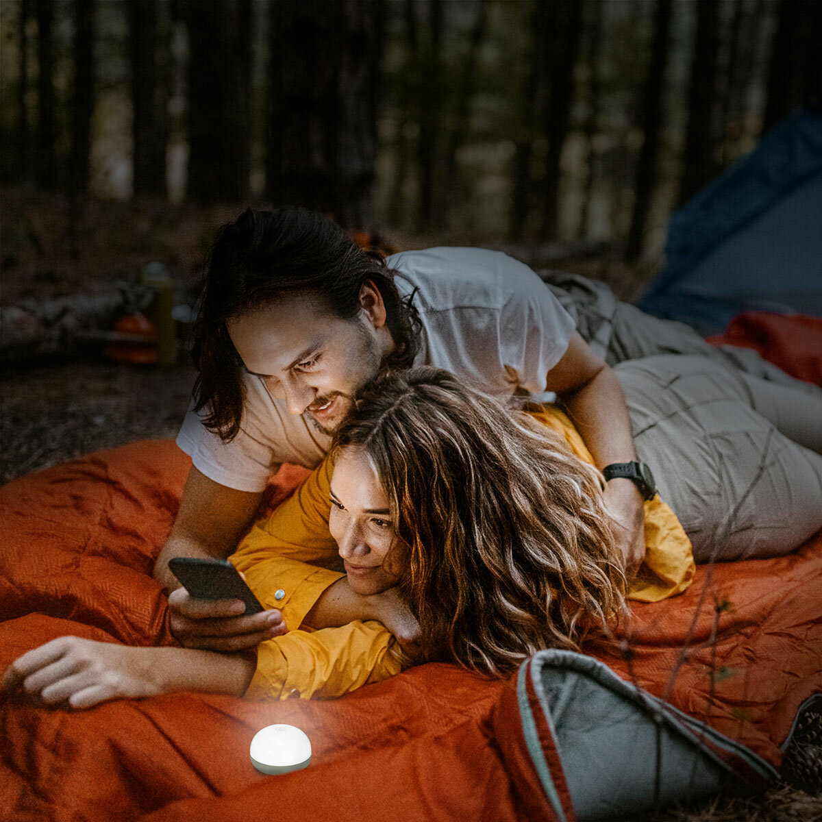 Lifestyle image showing a couple laying down next to the LED light Lifestyle image showing a couple laying down next to the LED light