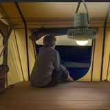Lifestyle image showing the camping fan hanging from the top of a tent Lifestyle image showing the camping fan hanging from the top of a tent