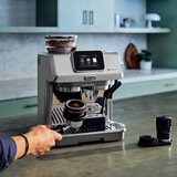 Lifestyle images of De'Longhi La Specialista Touch Coffee Machine being used on a kitchen countertop Lifestyle images of De'Longhi La Specialista Touch Coffee Machine being used on a kitchen countertop