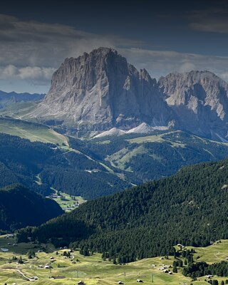 An iPhone 15 placed horizontally taking a picture of a picturesque mountain scene highlighting the super-high-resolution 48-megapixel camera