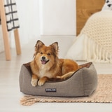 KS Rectangular Nuzzler grey dog bed with dog