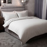 image showing full grey snug bundle set on a bed using the duvet cover, pillow cases and fitted sheet