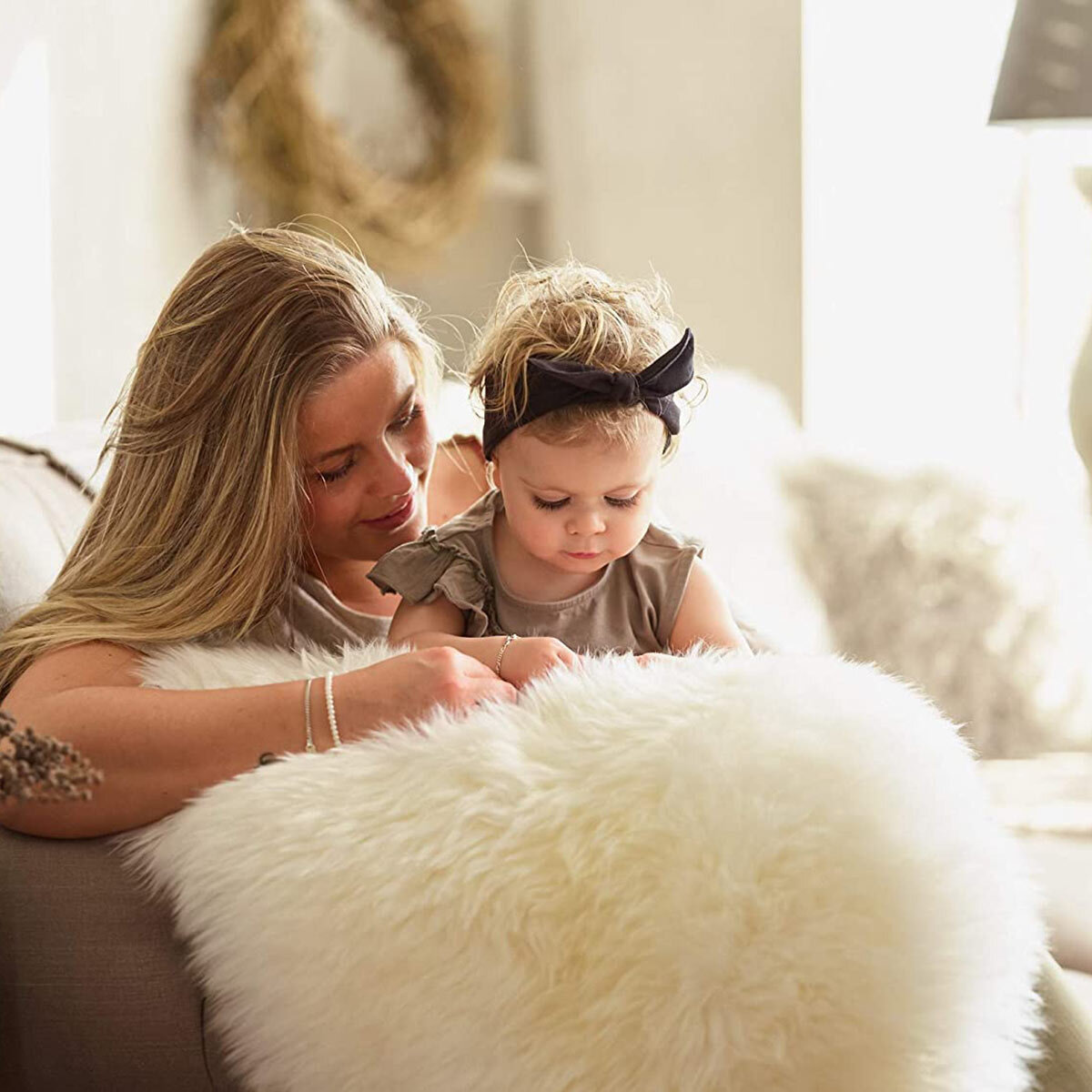 Naturally Sheepskin Double Rug in Ivory on sofa with mother and daughter