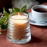 Lifestlye image of candle in clear glass