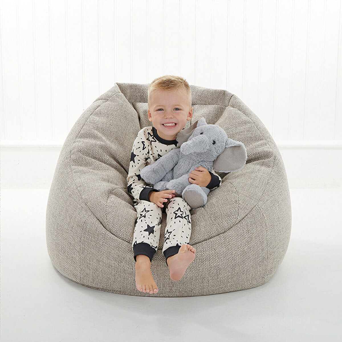 Boy Sitting Down Cuddling Elephant