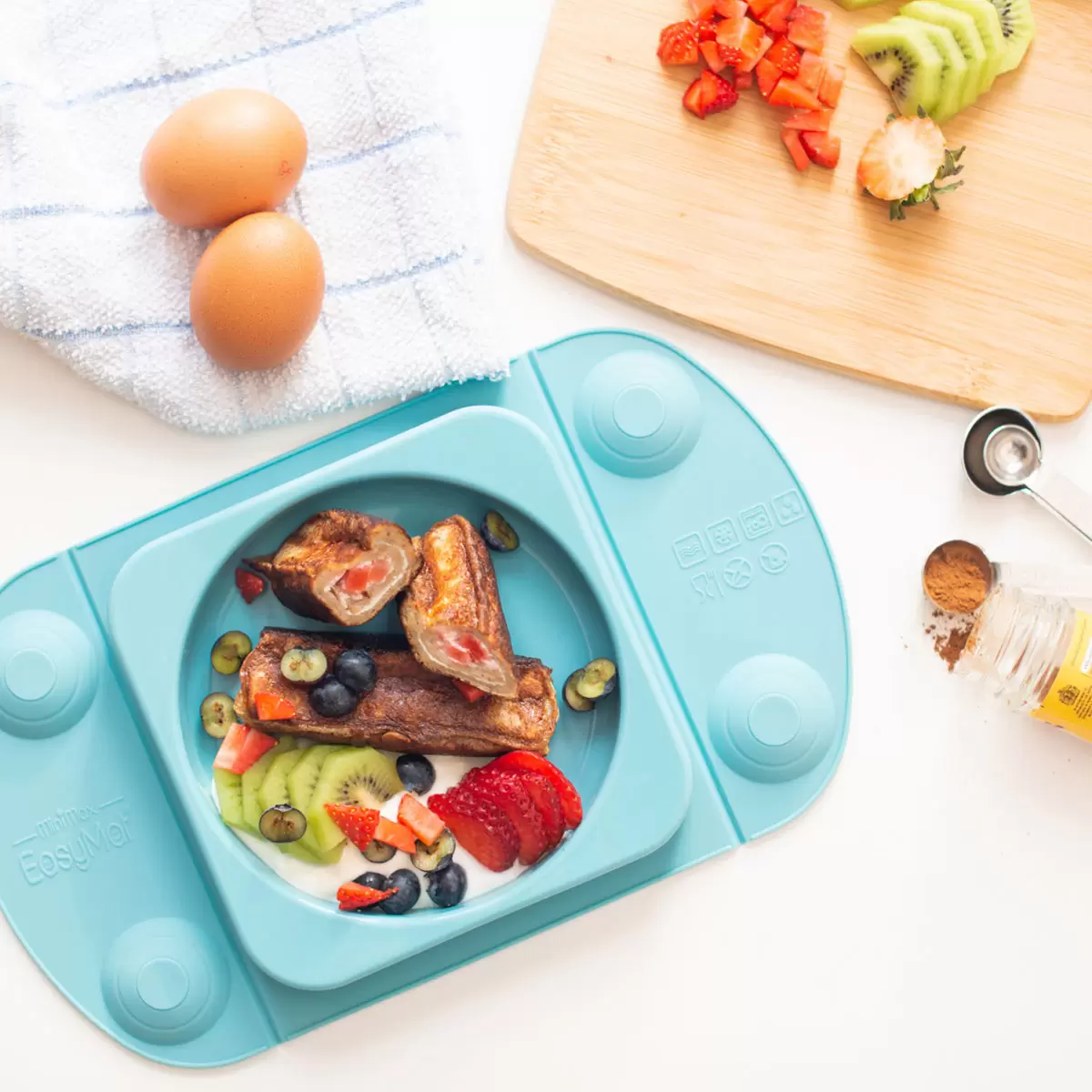 Lifestyle image of teal plate in kitchen environment