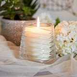 Lifestlye image of candle in clear glass