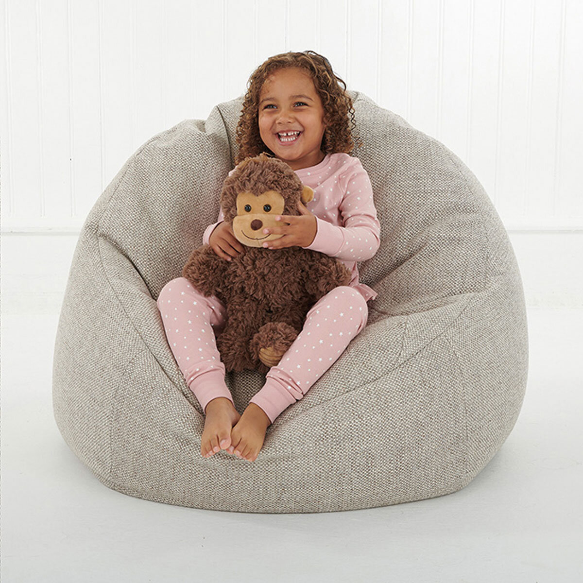 Girl Sitting Down Cuddling Monkey