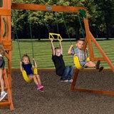 Lifestyle image of a child on the trapeze and two on the swings Lifestyle image of a child on the trapeze and two on the swings