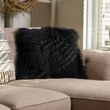 Naturally Sheepskin Mongolian Cushion in black close up on sofa