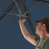 Lifestyle image of someone setting up the canopy Lifestyle image of someone setting up the canopy