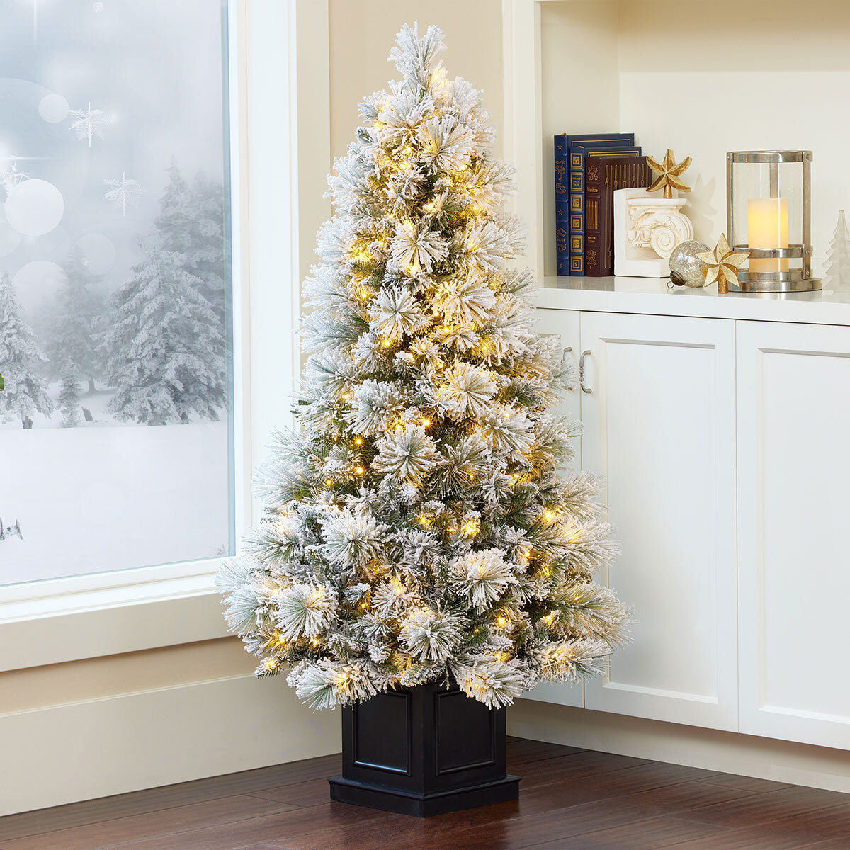 Buy 4.5ft Pre-lit Glitter Flocked Potted Tree Lifestyle Image 2 at costco.co.uk