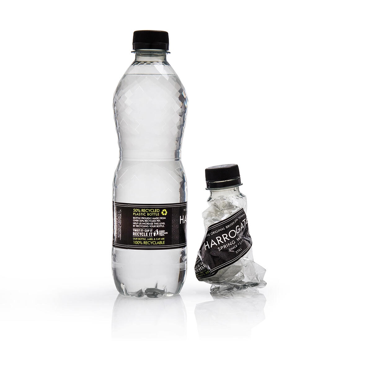 Cut out image of two bottles one crushed on white background