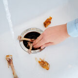 Lifestyle image of food being poured into sink