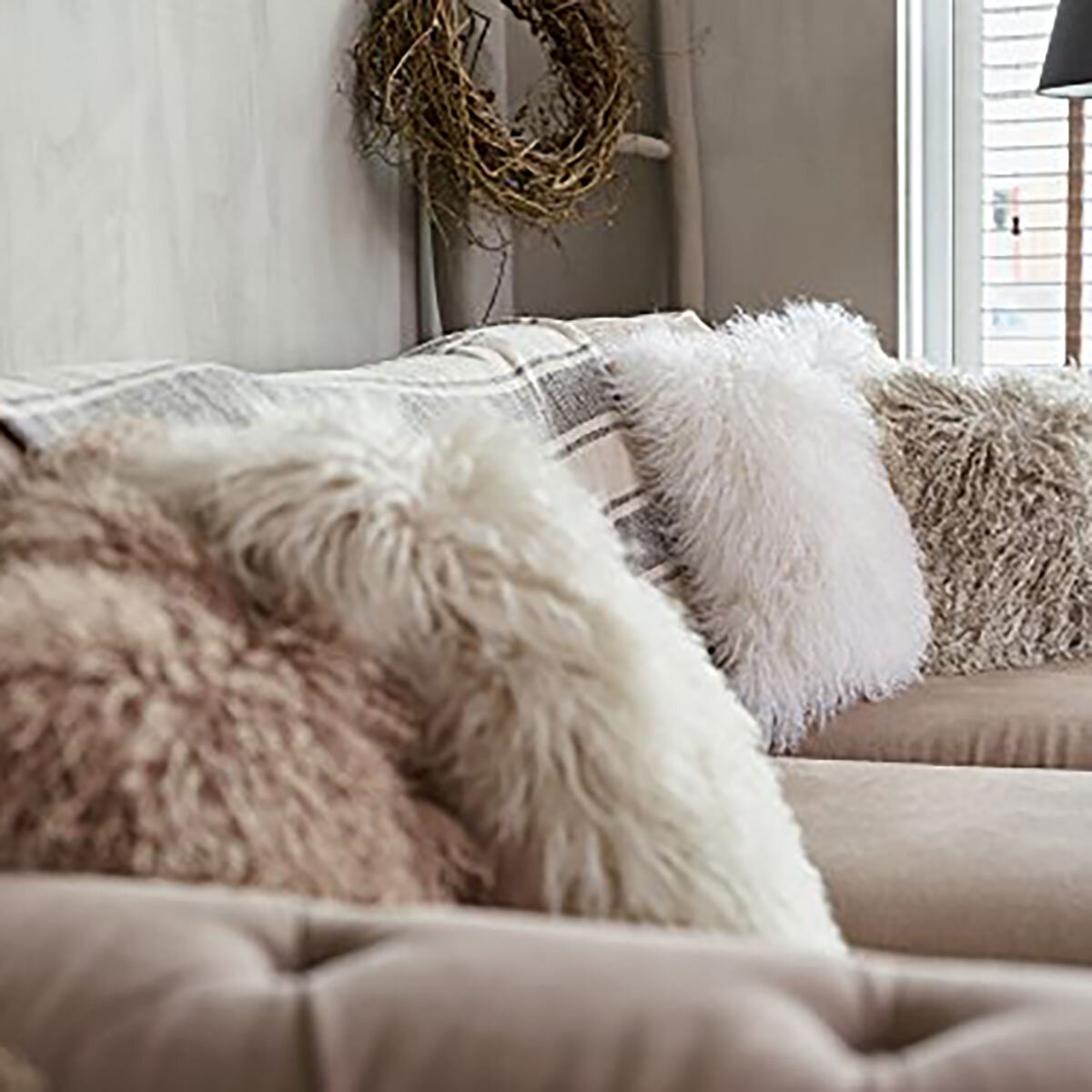 Naturally Sheepskin Mongolian Cushion in 4 colours on sofa