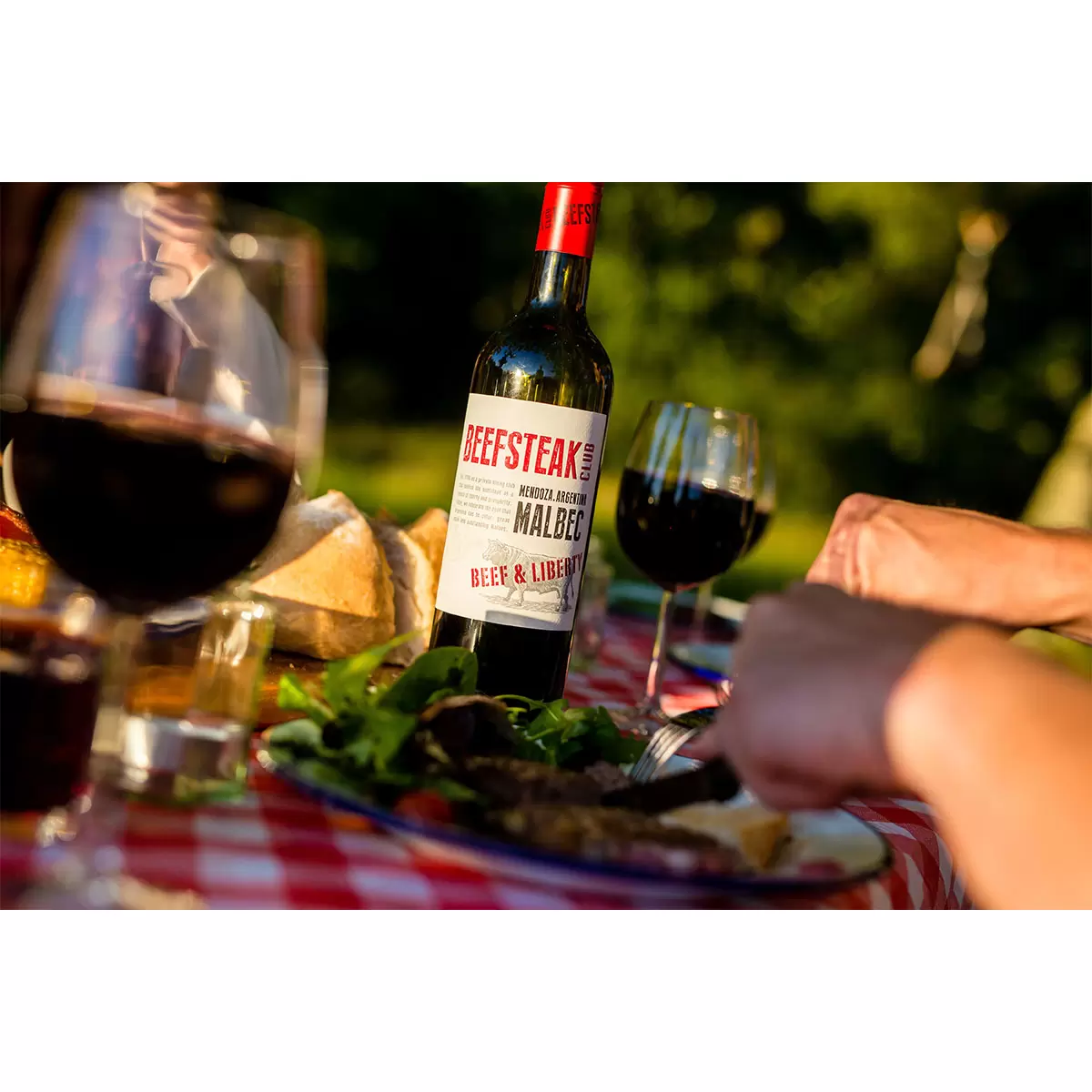 Image of bottle of wine in park