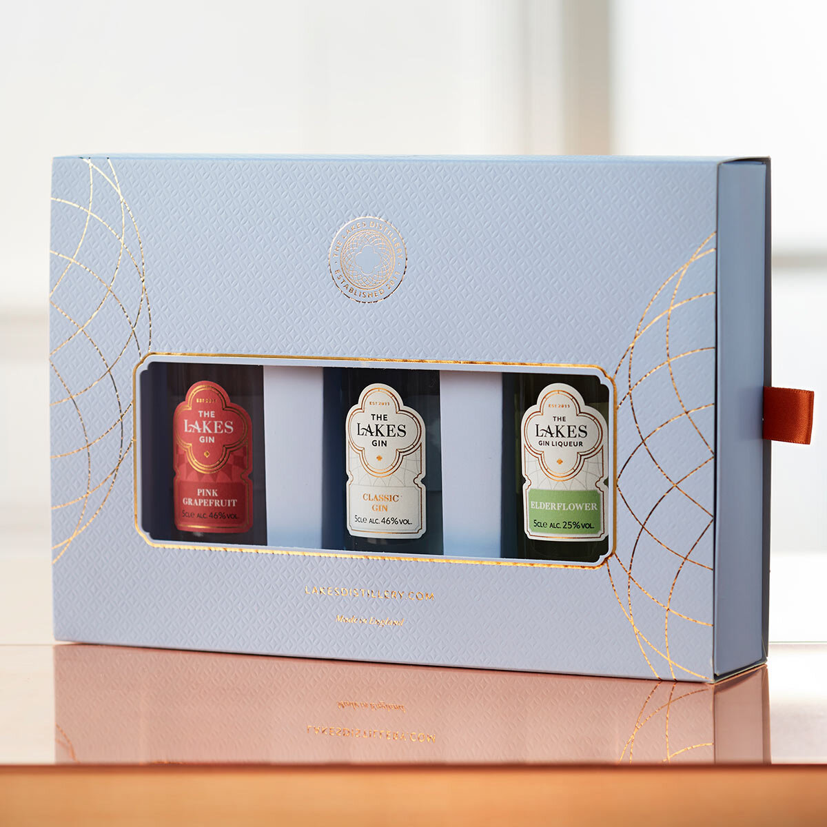Giftpack of 3 gins in blue cardboard box set on table