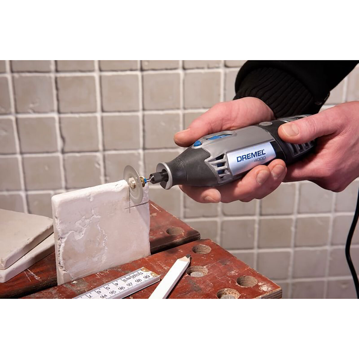 lifestyle image of multi-tool cutting tile
