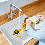 Lifestyle image of food being poured into sink