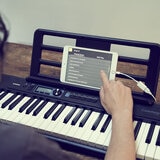 Lifestyle image of Casio CTS-300AD Portable Keybioard with Stand, Headphone & adapter in blacks