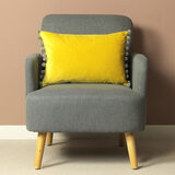 Lifestyle Image of Carnival Velvet Bolster Cushion on Accent Chair